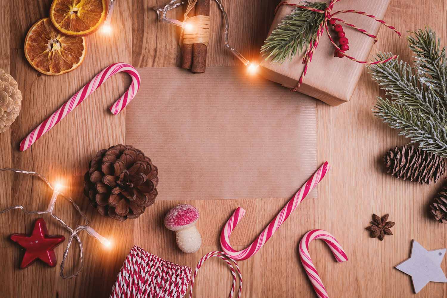 a christmas card with candy canes and pine cones